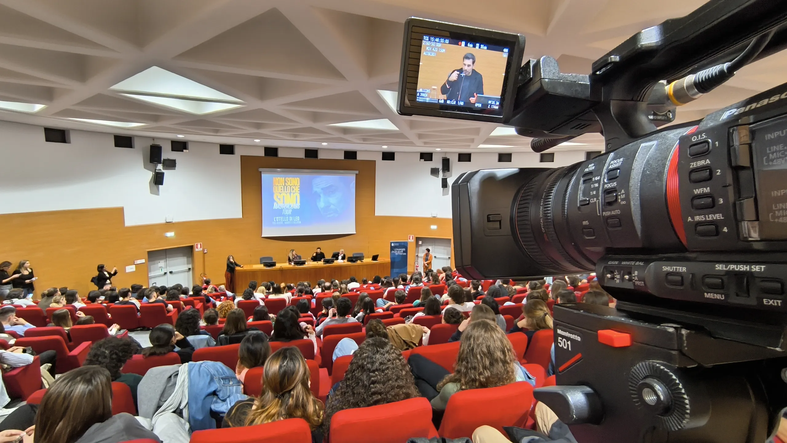 Auditorium universitario con primo piano di una telecamera